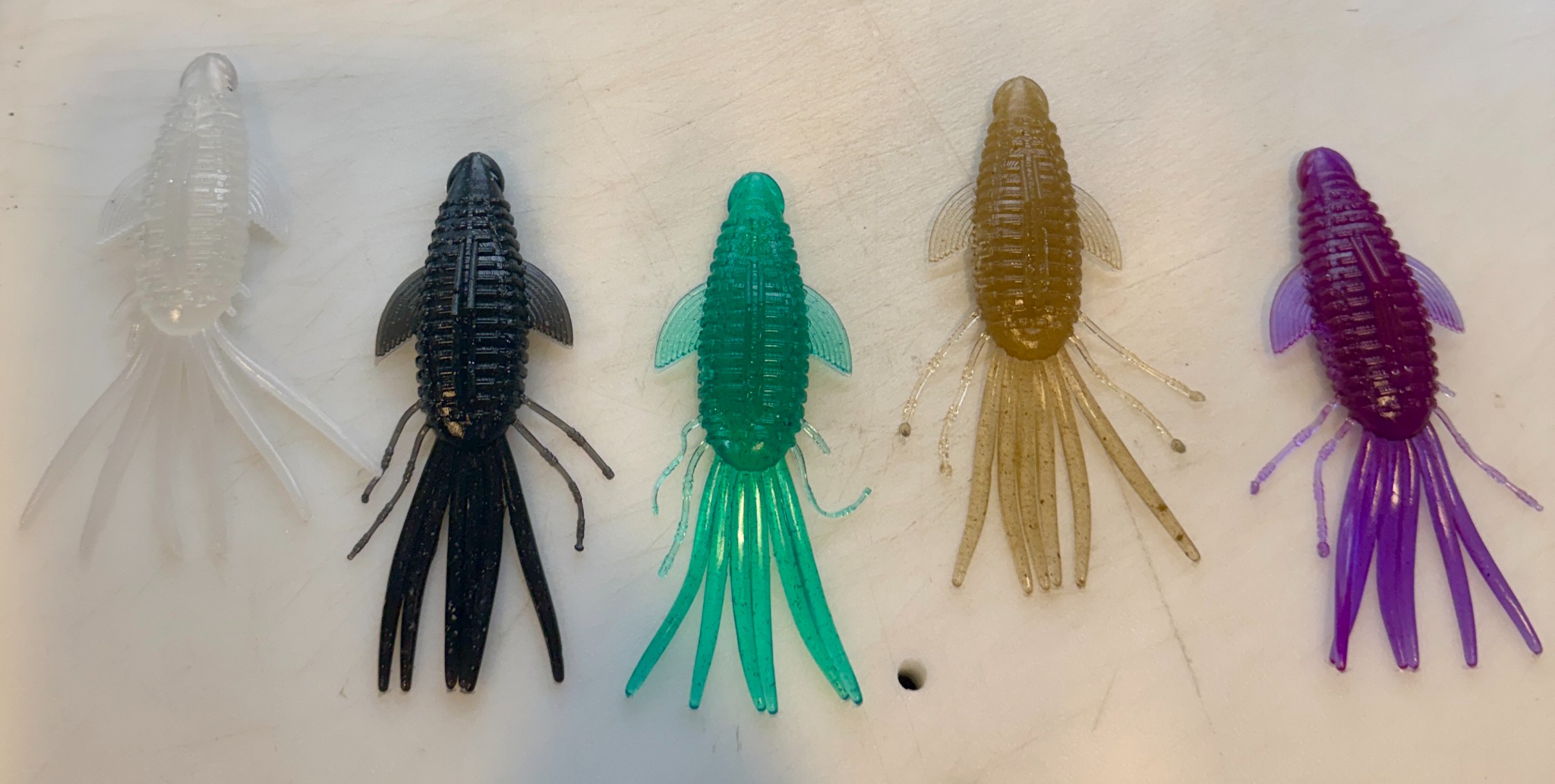 Five Pad Bug test pours side by side on the CBC workbench in clear pearl, black pearl, green, motor oil, and Junebug